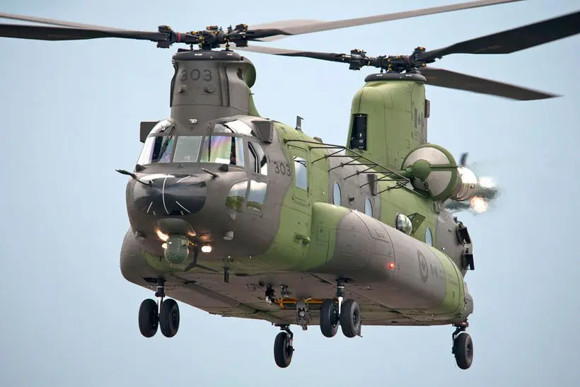 Image of a Canadian Air Force Chinook helicopter flying in a blue sky